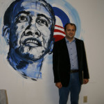 Oleg T poses by a portrait of Obama painted by a local high school student. Oleg T poses by a portrait of Obama painted by a local high school student.