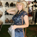 Natalia could not resist trying on some cowboy hats. Natalia could not resist trying on some cowboy hats.