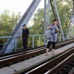 The river Prat separates Moldova and Romania. The bridge over it was built by Eiffel (of the Eiffel Tower.) Photos were permitted upstream, downstream, and into Moldova, but not Romania. Here Mariana is making sure she does not cross the wide red mark on the bridge which marks the actual border, while a Moldovan border guard stands nearby. Not seen in the photo is the Romanian guard standing at the far end of the bridge watching closely. The river Prat separates Moldova and Romania. The bridge over it was built by Eiffel (of the Eiffel Tower.) Photos were permitted upstream, downstream, and into Moldova, but not Romania. Here Mariana is making sure she does not cross the wide red mark on the bridge which marks the actual border, while a Moldovan border guard stands nearby. Not seen in the photo is the Romanian guard standing at the far end of the bridge watching closely.