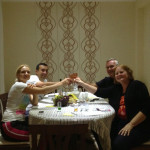 The Tindalls enjoy dinner with their hosts. The Tindalls enjoy dinner with their hosts.