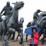 Barbara G. posed by one of the statues.