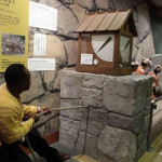 R. Jones demonstrates pulling stones to build the castle.