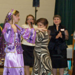 Gunel, dressed in traditional Azerbaijani costume, and Gulchohra share a traditional dance and song at the annual FFCNC meeting.