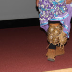 This lady is wearing a turtle shell rattle which was used in the dance.