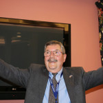 Ray Kiszely, also co-exchange director, began his remarks with a display of the US and Kosovar flags.