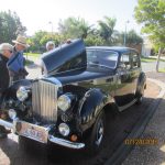 Jim N. admired an old restored car with his host. Jim N. admired an old restored car with his host.