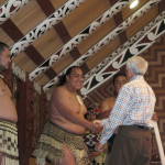 Jim N. greets a Maori native during a visit to the Maori Community House on the North Island.