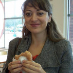 Ahu tastes a Krispy Kreme doughnut.