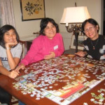 Arty, Eka, and Paulina with NC jigsaw puzzle.