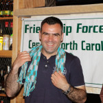 Hartim Gashi modeling a scarf from a local immigrant group.